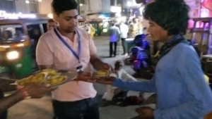 Man near Bareilly railway junction receiving food during a food distribution drive, showcasing efforts to combat hunger and support the underprivileged.