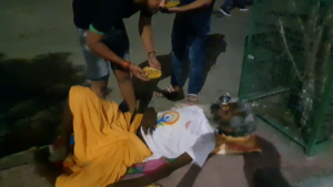 Man near Bareilly railway junction receiving food during a food distribution drive, showcasing efforts to combat hunger and support the underprivileged.