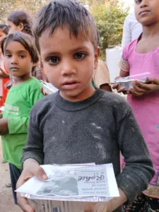 kid having food from aapke saath foundation's food drive