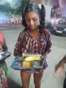 food distribution for a poor slum kid in delhi