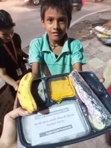 food distribution for a poor slum kid in delhi