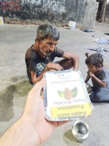 Volunteers serving food to homeless on a birthday event