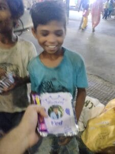 food and chocolate during a distribution event in Delhi organised by aapke saath foundation.