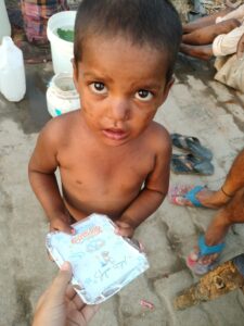 A poor boy in a slum of Delhi receiving food during a birthday distribution event organized by Aapke Saath Foundation