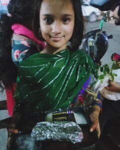 A girl enjoying a meal from the food distribution organized by Aapke Saath Foundation's 'Food for Every Breath' campaign.