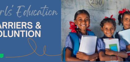 Three smiling girls holding books and notebooks, representing the article 'Barriers to Girls' Education in India.
