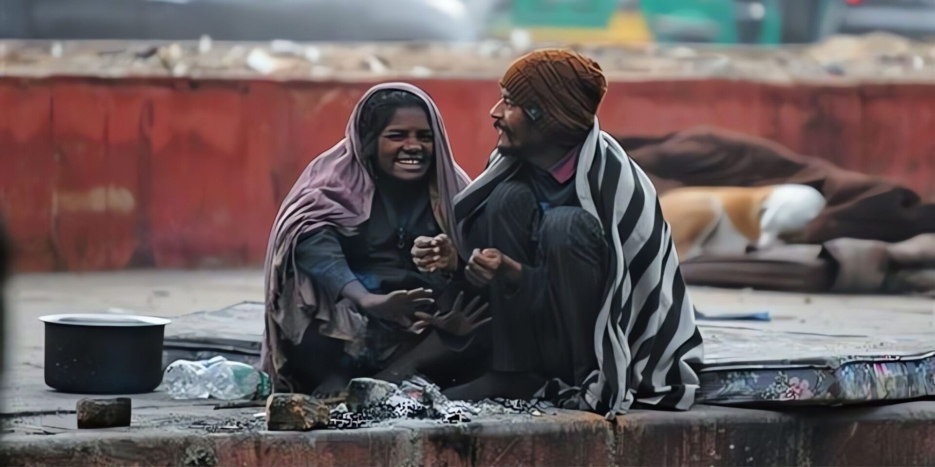 a girl and his fater sitting near to fire to get warn in col weather