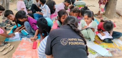 Slum children receiving free education support from Aapke Saath Foundation volunteer in Bareilly, promoting child education and NGO outreach.