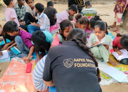 Slum children receiving free education support from Aapke Saath Foundation volunteer in Bareilly, promoting child education and NGO outreach.